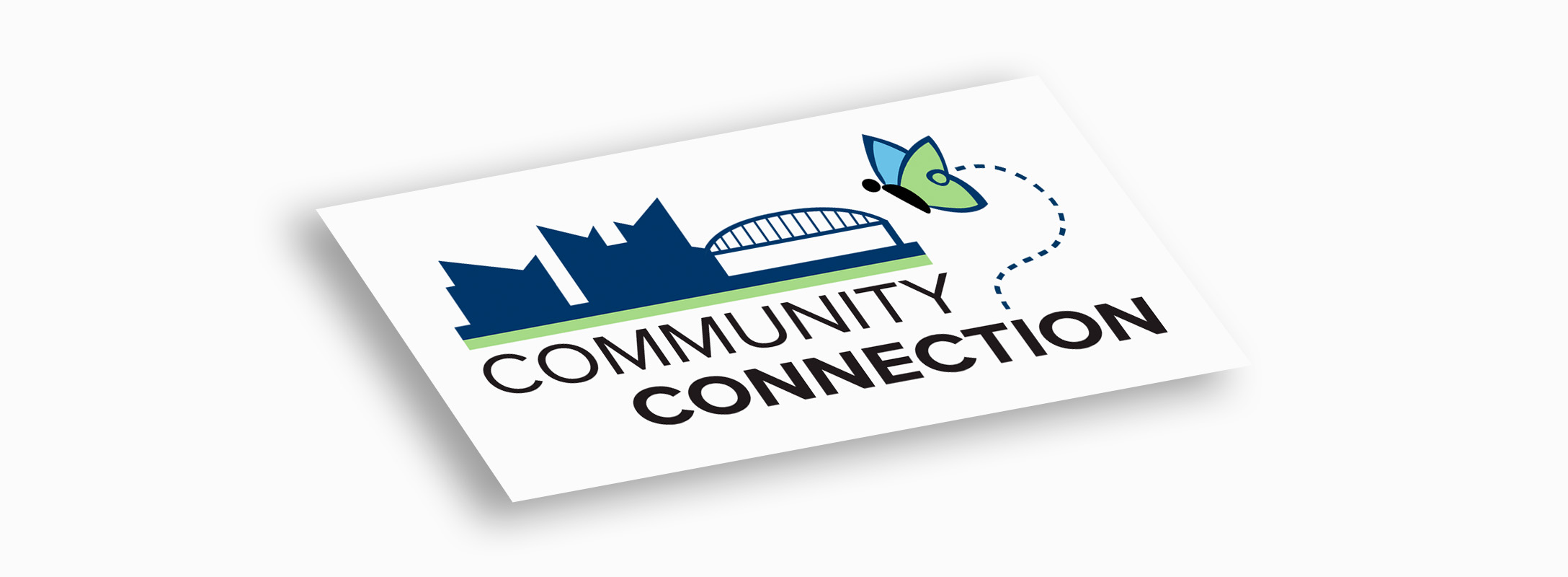 The final Community Connection logo — a Chattanooga skyline with the parent brand's butterfly and a dashed connection path, on a business card