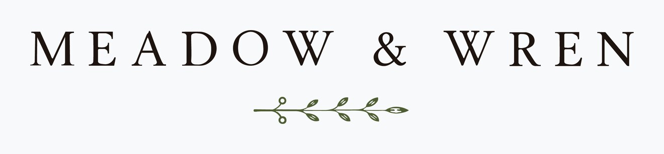 The Meadow and Wren horizontal lockup — wordmark on one line above a centred sprig