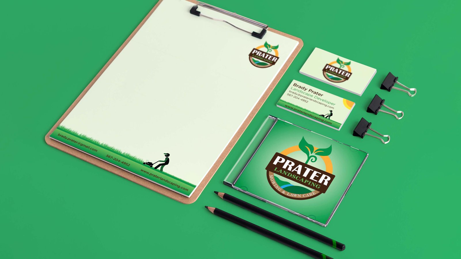 Prater Landscaping stationery suite — letterhead and business cards flat-lay with an illustrated lawn-mowing figure