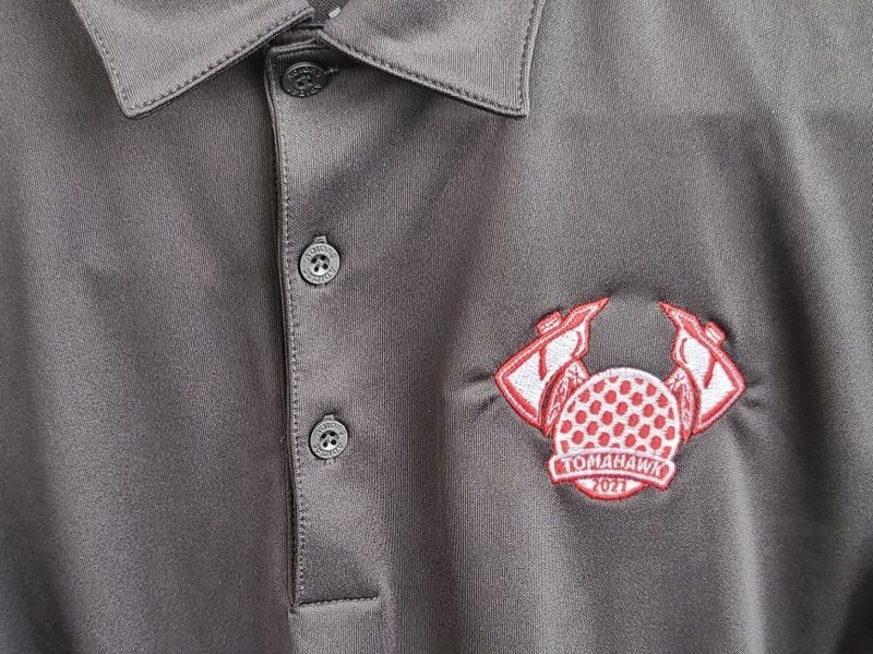 Team Tomahawk badge embroidered on a charcoal polo